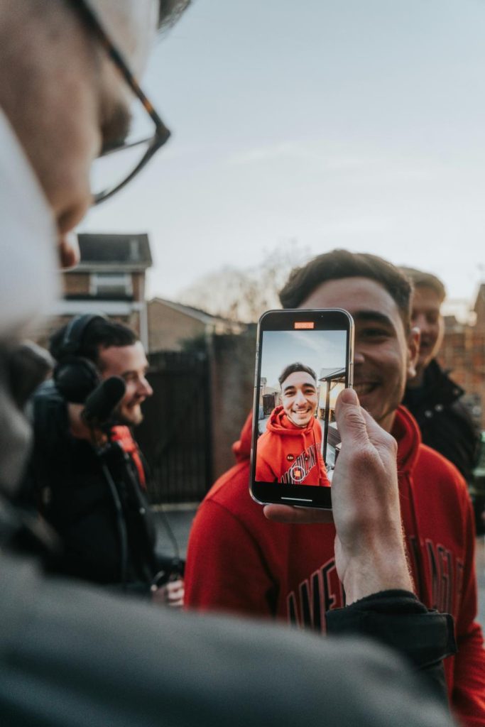 Person taking selfie with phone