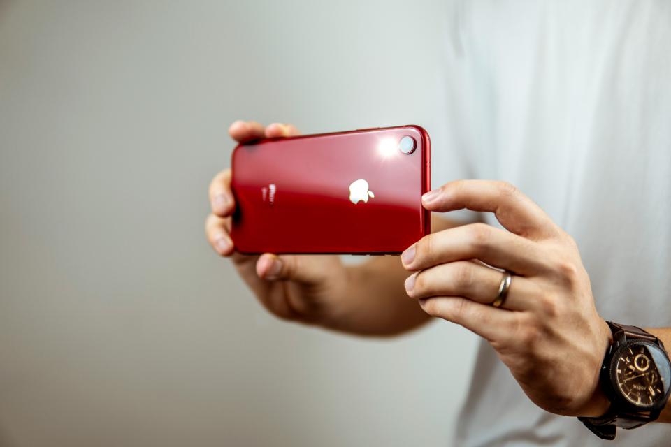 Person holding a red phone